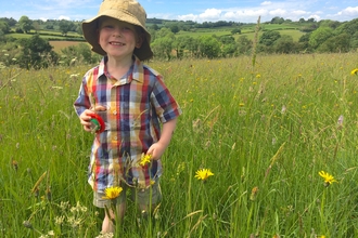 Bryn playing in a meadow