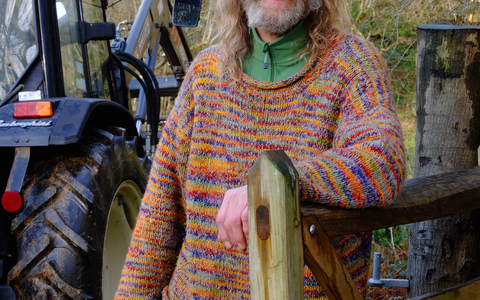 Rob standing next to a tractor holding wire