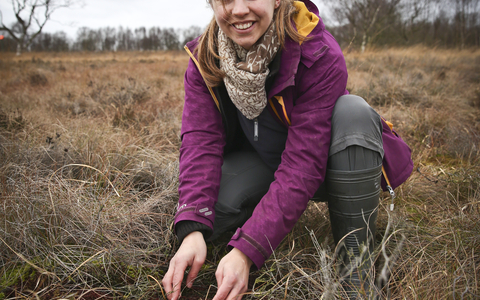 Elspeth holding soil in a wetland