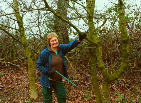 Anne with a saw in the woods